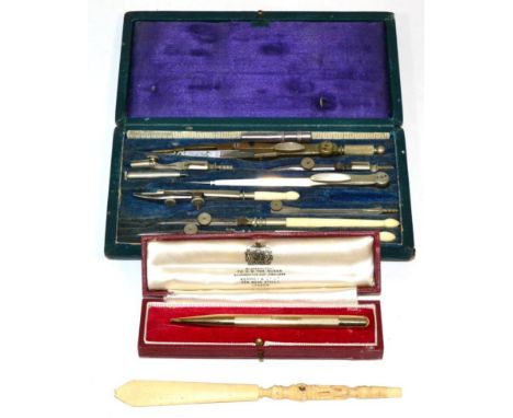 An Asprey 9 carat gold engine engraved propelling pencil, cased; a Stanhope viewer and a set of drawing instruments 
