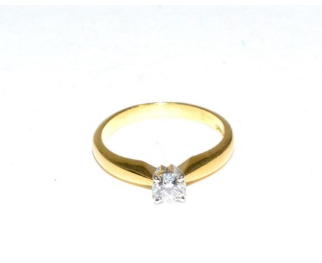 An 18 carat gold solitaire diamond ring, a round brilliant cut diamond in a claw setting, to knife edge shoulders, estimated 