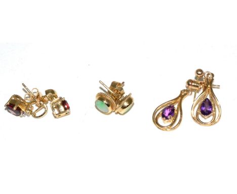 A pair of 9 carat gold cabochon jade earrings; a pair of garnet and diamond drop earrings, stamped '375'; and a pair of ameth