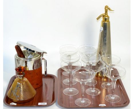 A group of Art Deco style items comprising, a soda syphon, an ice bucket, liquor decanter and nine champagne glasses (two tra
