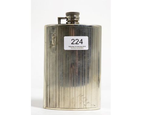 A white metal hip flask, stamped 'Silver', of curved form with engine turned decoration, 15cm high, 10ozt 