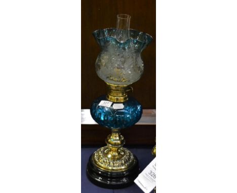 A late 19th century brass oil lamp with floral etched shade 