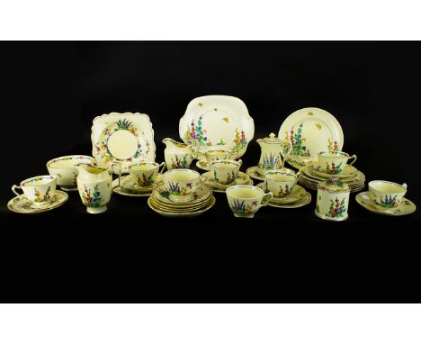 A Crown Staffordshire Part Tea Service on a white background with blue, yellow and pink flowers, butterflies and birds. Appro