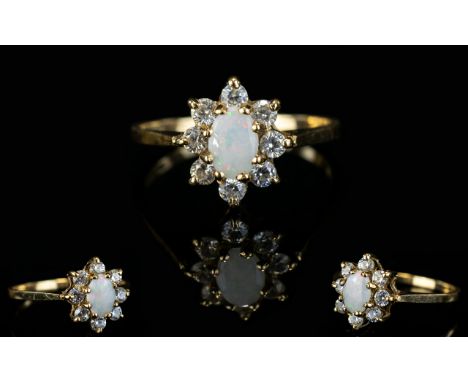 Ladies 1970's 9ct Gold Opal and Diamond Set Cluster Ring Flower head design. The central Opal surrounded by 8 Diamonds of goo