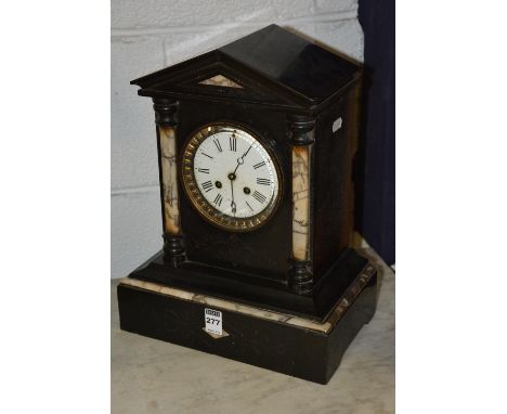 A Victorian black slate and marble mantel clock, the white enamel dial with Roman numerals, flanked by marble column pillars,
