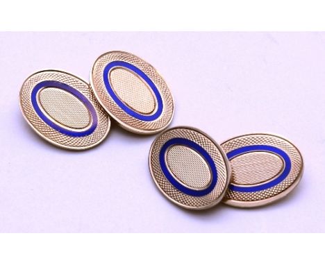 A pair of 9ct gold and lapis lazuli cufflinks, the oval band of lapis lazuli with engine turned gold detail to centre and cro