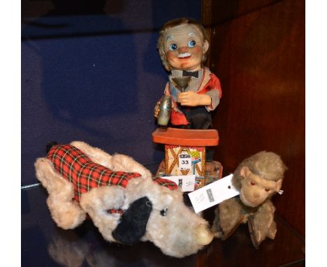 A vintage automaton bartender, stood behind bar with cocktail shaker and glass, together with a toy monkey automaton with cym