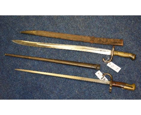 Two 19th century French bayonets, with leather and metal scabbard, 52cm x 56.5cm long