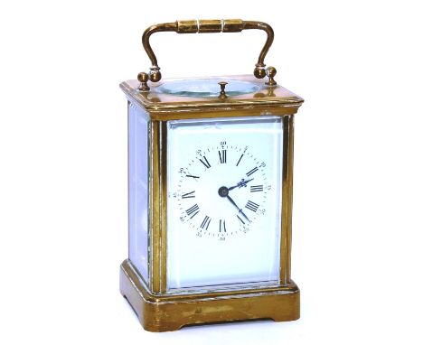 A brass repeating carriage clock, the white enamel dial with Roman numerals, twin train movement, with carry handle, 20cm hig