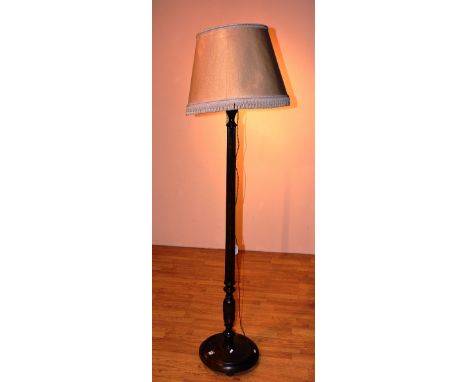 A mahogany fluted floor lamp with shade, raised on circular foot, 175cm high