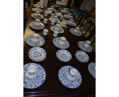 A Meissen style porcelain dinner/tea service, decorated with blue floral panels on white ground, approx 125 pieces
