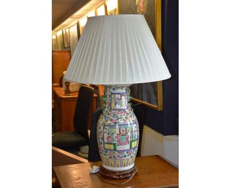 A 19th century Chinese 'Famille Rose' vase table lamp with shade, decorated with panels of figures in fruit and foliage, 48cm