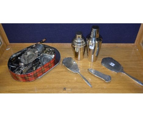 A Birmingham 1955 silver backed dressing table set, comprising of mirror and two brushes, the engine turned back with foliate