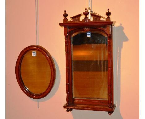 An Edwardian mahogany wall mirror, decorated with pillar columns, 68cm high, also with mahogany oval wall mirror with wood ba
