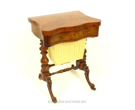 A Victorian walnut veneer and mahogany, games table with folding top featuring an interior chess backgammon and cribbage boar