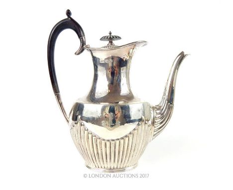 A Victorian hallmarked sterling silver coffee pot assayed in Sheffield in 1900, made by Lee and Wigfull, having an ebony hand