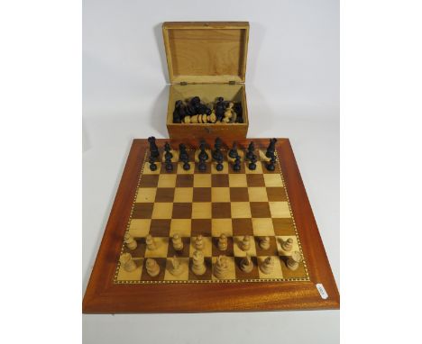 Beautifully made chess board with inlaid parquetry along with two sets of chess pieces housed in a vintage wooden Lotto box. 
