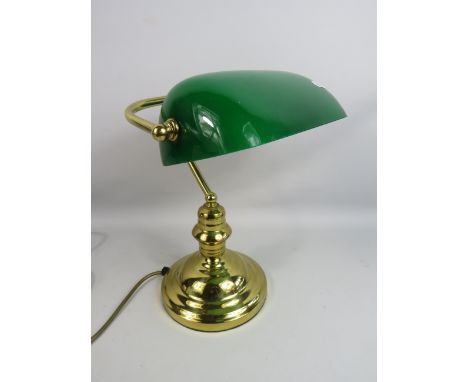 Brass banker lamp with green glass shade.