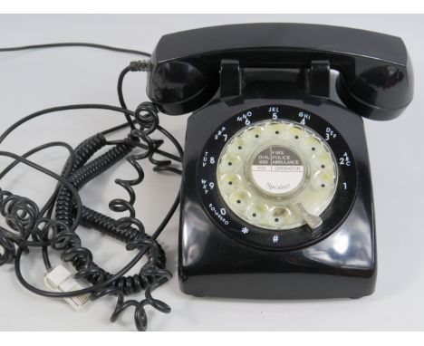 Vintage black plastic rotary telephone.
