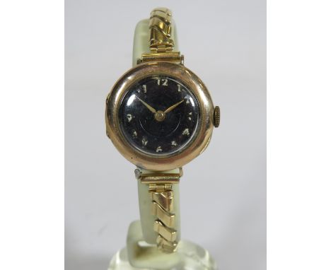Ladies watch with Black face and white numerals, vintage era, 9ct gold Case, Swiss import marks, Running order.. Will need re