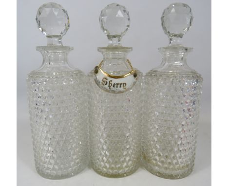 3 Matching crystal glass decanters and a Limoges ceramic decanter label. approx 28cm tall.