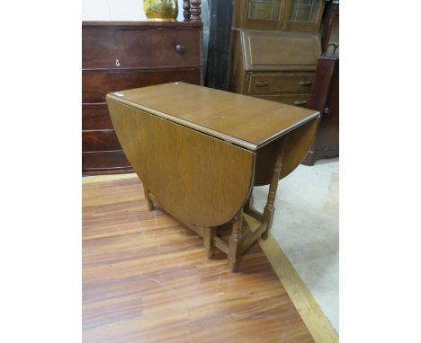 Drop leaf gate leg oval topped table of good grain and colour  H:29 x W:59 (extended) x D:35 Inches. See photos. S2
