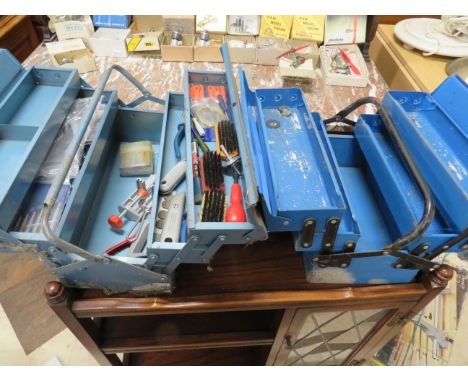 Two metal cantilever tool boxes, one has some tools within. See photos.   S2