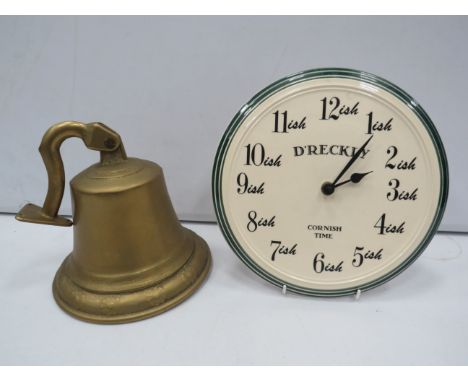 Large wall mounted brass bell and a Ceramic Cornish clock.