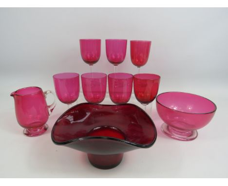 Selection of vintage cranberry glass and a red art glass bowl.