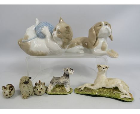 Nao figurine of a cat with a ball of wool plus a selection of other figurines.