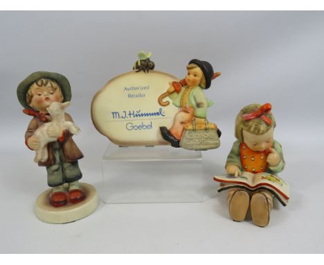 2 Goebel Hummel Figurines "Lost Sheep" Tmk1 and "Bookworm" Tmk3 (both have slight damage ) plus a Retailers Plaque.