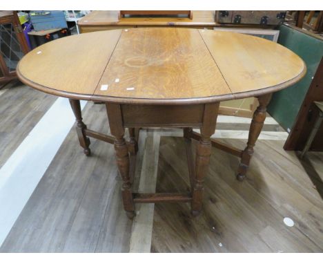 Stylish Light oak gate leg drop leaf table of good construction.     H:29 x W:50 x D:36 inches. See photos.    S2