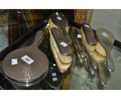 A silver dressing table set, comprising two hair brushes, two clothes brushes, hand mirror;  shoe horn and button hook, engin