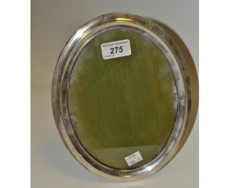 A silver oval easel photograph frame, wooden back, 24.5cm x 19.5cm, Birmingham 1923