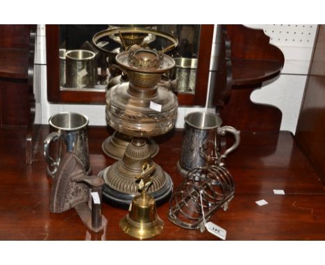 A Victorian brass oil lamp, clear glass reservoir, another; a pair of silver plated tankards, a silver plated toast rack ; et