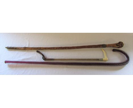 Glass candy cane walking stick, wooden walking stick and a riding crop
