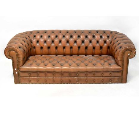 A brown leather Chesterfield three-seater settee with button back, length approx. 206cm.Condition Report: - There is some dam