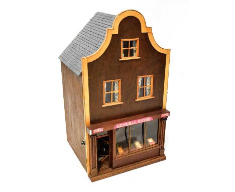 A dolls' house modelled as a General Store, with three interior floors, containing figures, furniture, shop fittings and stoc
