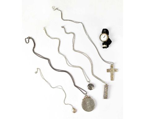 A hallmarked silver ingot pendant, length 4.1cm, Sheffield 1977, on a white metal chain, length 50cm, a cross pendant with fl