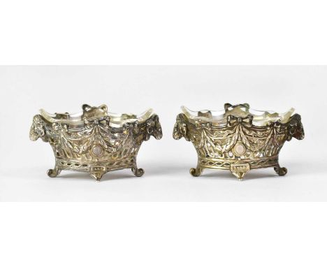 A pair of American sterling silver marquise-shaped pierced salts decorated with rams' heads, bows and swags, each on two acan