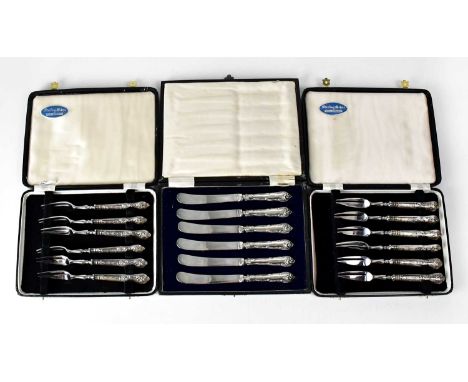 A set of six butter knives with hallmarked silver handles and silver-plated blades, and two sets of six oyster forks with hal