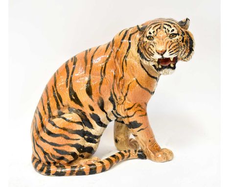 A large ceramic figure of a seated tiger, unmarked, height 50cm.Condition Report: Tiger is crazed and displays various firing