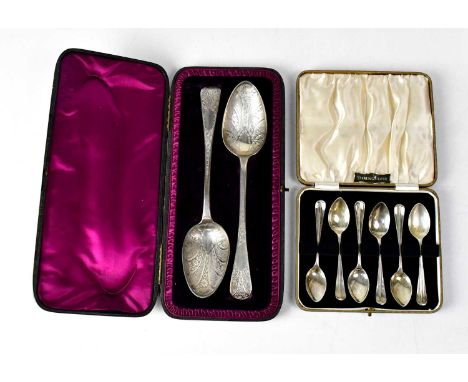 A near pair of hallmarked silver spoons with floral and foliate engraving and vacant cartouches to the terminals, length 22.2