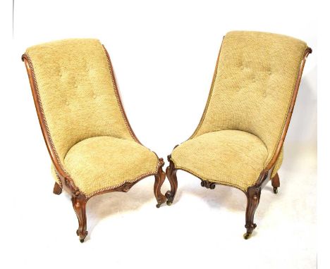 A pair of walnut framed slipper chairs, recently reupholstered with beige button pressed fabric and gilded rope detail, raise