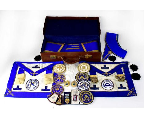 Masonic regalia comprising three aprons, collars, rosettes, gloves, apron badges and three jewels, one in a Toye &amp; Co Ltd