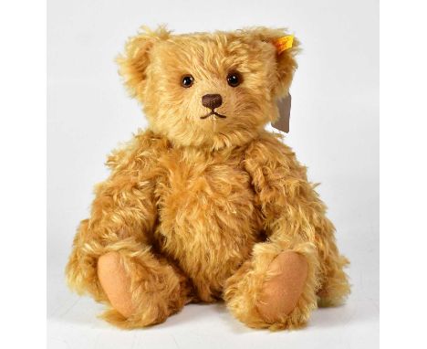 STEIFF; a golden bear, with growler, gold button and tag to ear, height 34cm.