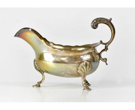 WILLIAM SKEEN; a George III hallmarked silver sauce boat with double scroll handle, to three hoof feet, London 1765, height t