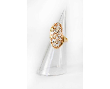 A c.1970s yellow metal ring set with fourteen various sized diamonds, the largest approx. 0.4ct, in an open abstract form, si