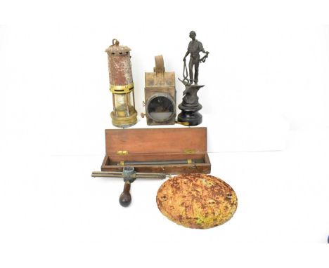 Mixed collectibles including a miner's lamp, a carbide lamp, a statue of a blacksmith, on socle base, height 30cm, a cast iro