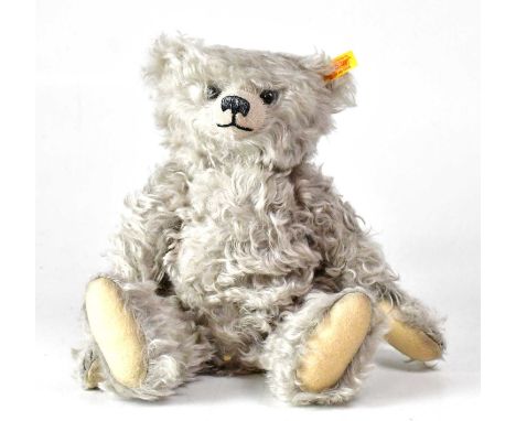 STEIFF; a grey mohair bear, with growler, gold button and tag to ear, height 34cm.